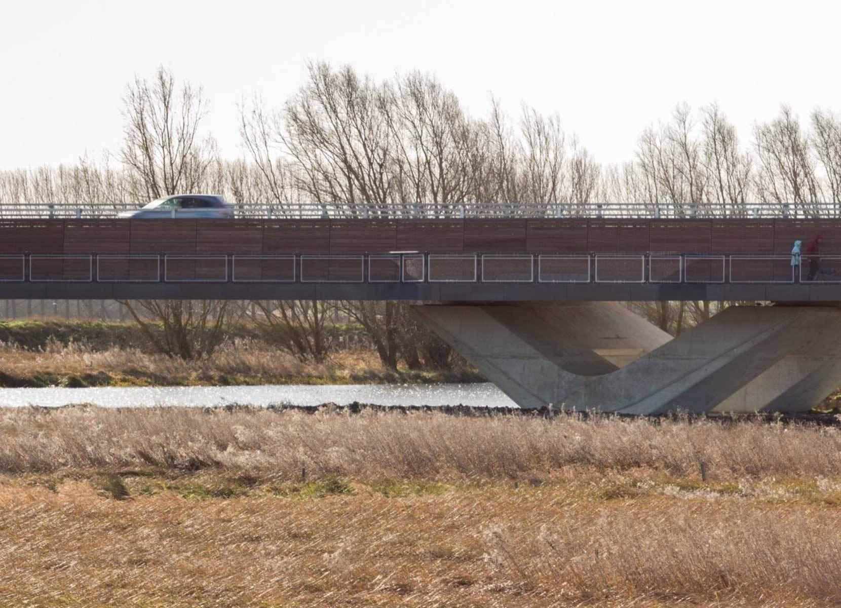 A modern road bridge with separated walk-way suspended by elegant, angled piers